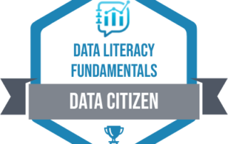 The data citizen badge. Blue hexagon with grey ribbon that says Data Citizen. Above the ribbon is the blue data literacy logo followed by Data Literacy Fundamentals in blue text. Below the ribbon, but still within the hexagon is a blue medal.