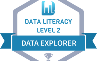 Blue badge with data literacy logo at top and an award at the bottom. Blue ribbon across reads data explorer. Below logo it reads data literacy level 2.