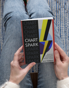 woman holding the chart spark book